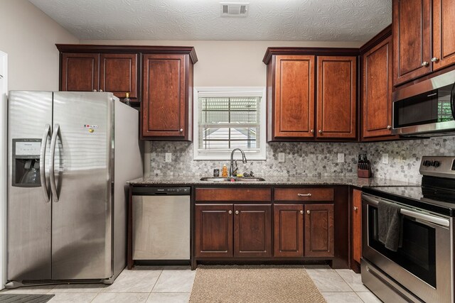 344 Lee Road 2040, Phenix City, AL 36870 - kitchen featuring appliances with stainless steel finishes, dark stone counters, backsplash, and light tile patterned floors