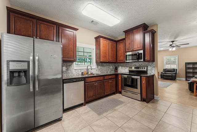 344 Lee Road 2040, Phenix City, AL 36870 - kitchen featuring appliances with stainless steel finishes, tasteful backsplash, open floor plan, a ceiling fan, and dark stone counters