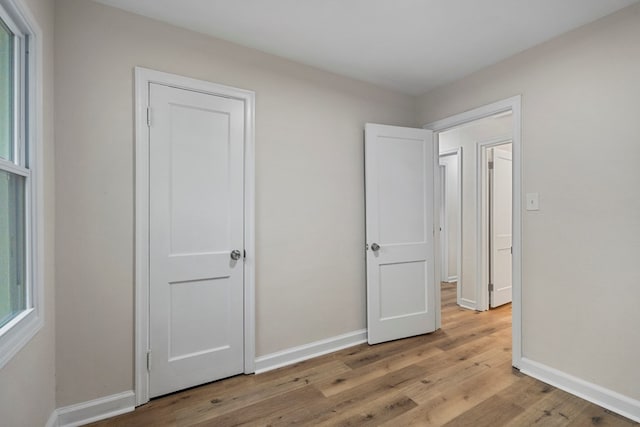 1474 Brewer Ave, Columbus, GA 31903 - unfurnished bedroom featuring multiple windows and light hardwood / wood-style flooring