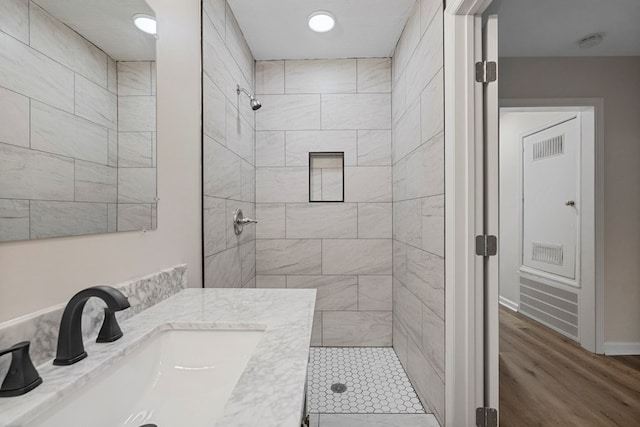 1474 Brewer Ave, Columbus, GA 31903 - bathroom featuring vanity, tiled shower, and hardwood / wood-style floors