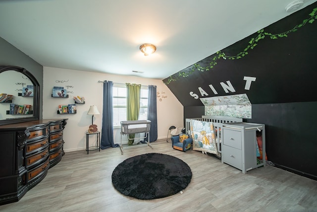 game room featuring light hardwood / wood-style floors and vaulted ceiling