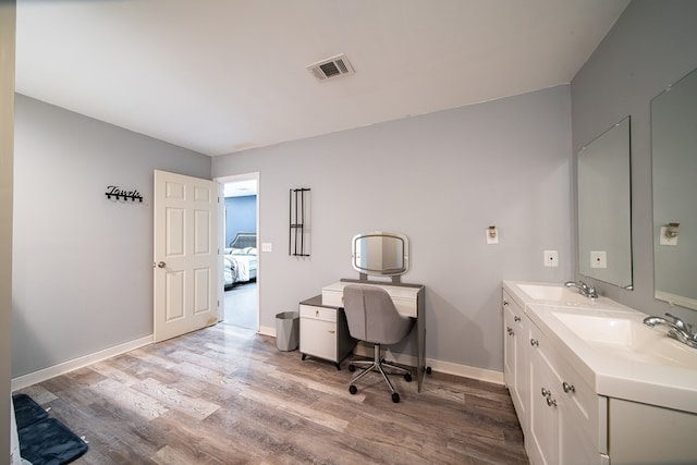 office area featuring light wood-type flooring and sink