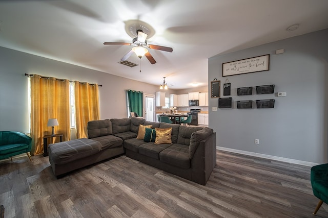 living room featuring dark hardwood / wood-style floors and ceiling fan