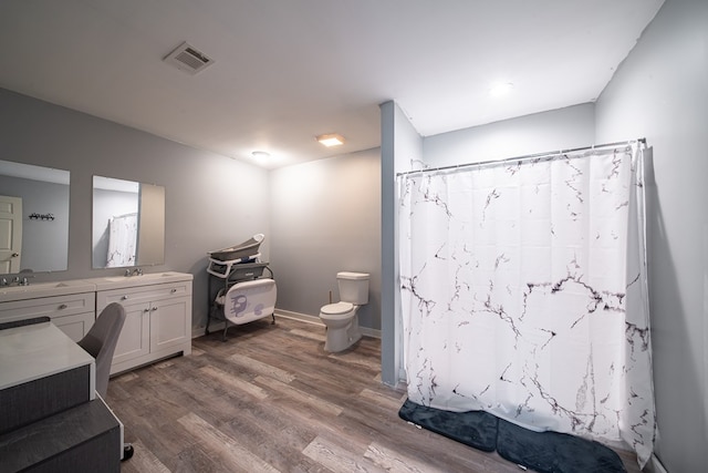 bathroom featuring hardwood / wood-style floors, vanity, and toilet