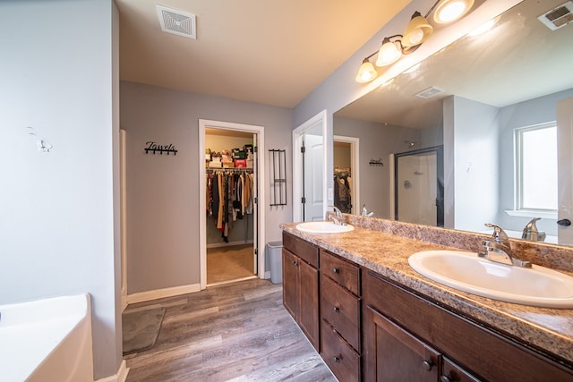 bathroom featuring vanity, an enclosed shower, and hardwood / wood-style flooring