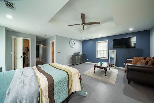 bedroom featuring ceiling fan and a tray ceiling