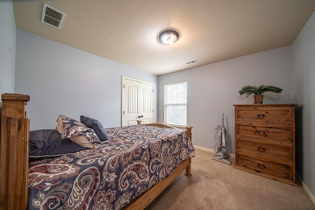 bedroom featuring light carpet and a closet