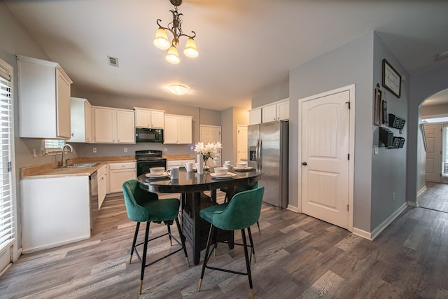 kitchen with sink, white cabinets, black appliances, and dark hardwood / wood-style floors