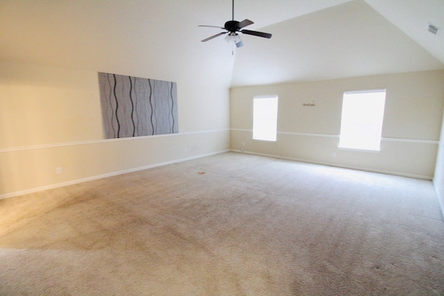 carpeted spare room featuring a ceiling fan, baseboards, and high vaulted ceiling