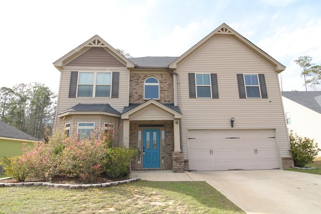 view of front of property featuring brick siding, driveway, a front lawn, and a garage