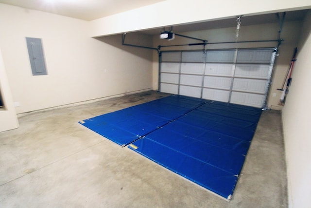 garage with electric panel and a garage door opener