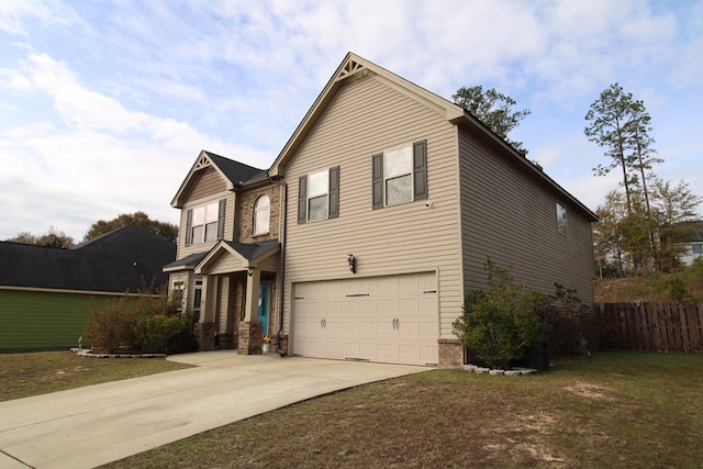 traditional-style house featuring a front yard, concrete driveway, an attached garage, and fence