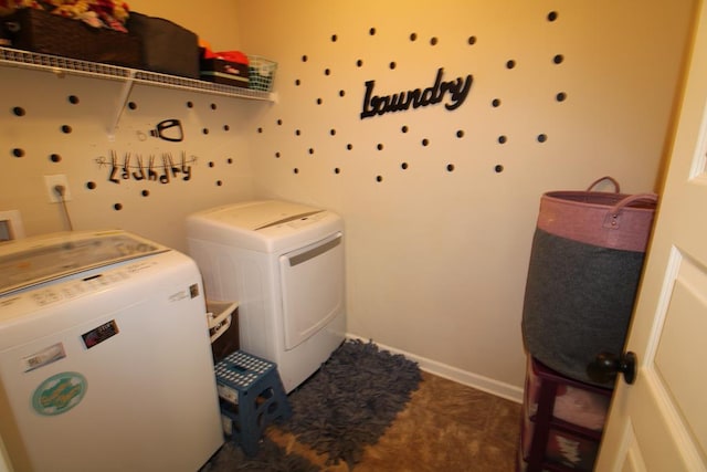 clothes washing area with washer and clothes dryer, laundry area, and baseboards