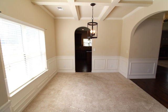 unfurnished room with arched walkways, beamed ceiling, coffered ceiling, and visible vents