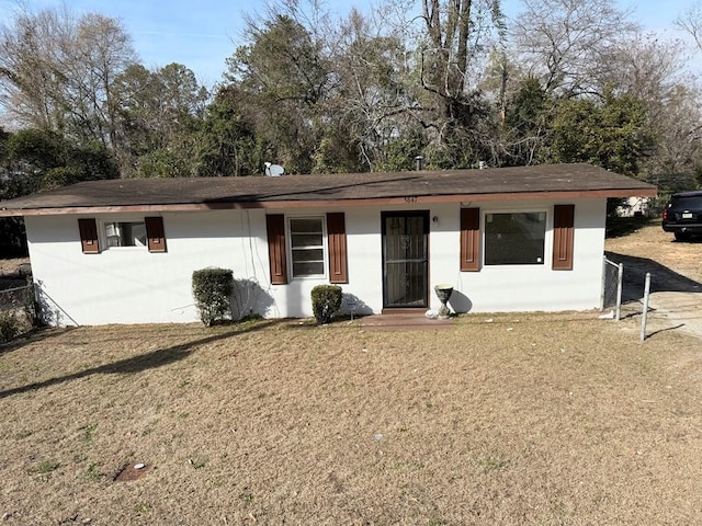 ranch-style home with a front lawn