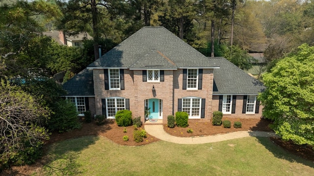 4975 Glacier Dr, Columbus, GA 31907 - colonial house with a shingled roof, a front lawn, and brick siding