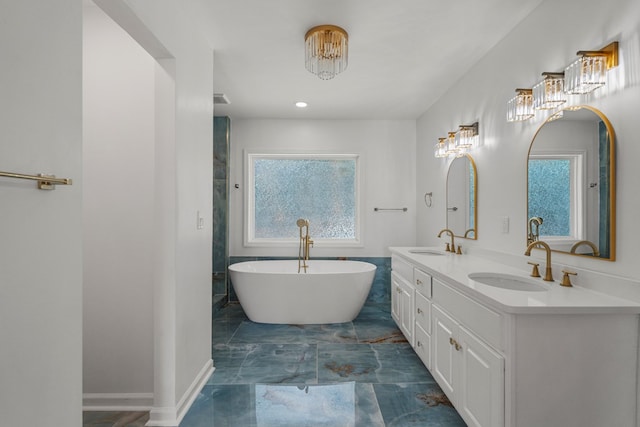 4975 Glacier Dr, Columbus, GA 31907 - bathroom featuring marble finish flooring, double vanity, and a soaking tub