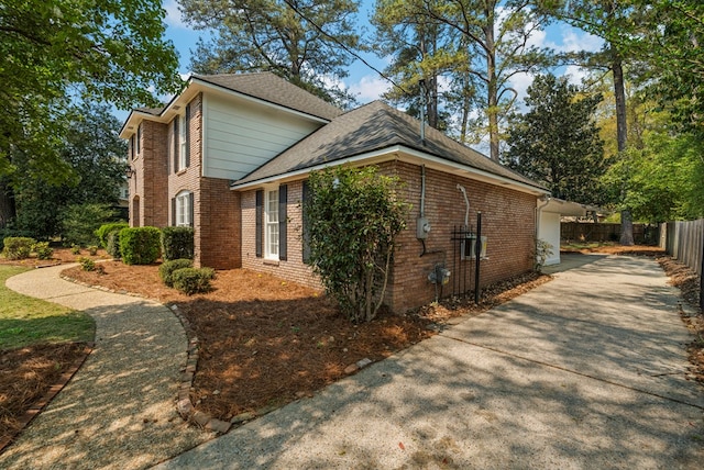 4975 Glacier Dr, Columbus, GA 31907 - view of property exterior with driveway, brick siding, and a shingled roof