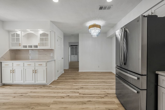 4975 Glacier Dr, Columbus, GA 31907 - kitchen with freestanding refrigerator, open shelves, white cabinets, a chandelier, and recessed lighting