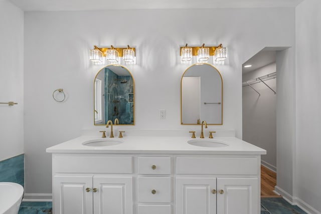 4975 Glacier Dr, Columbus, GA 31907 - full bathroom with a shower with shower door, double vanity, a spacious closet, and a freestanding tub