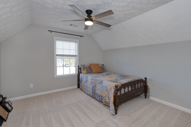 carpeted bedroom featuring ceiling fan, a textured ceiling, and vaulted ceiling