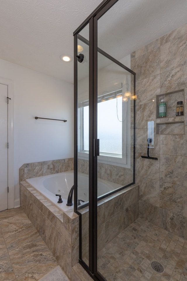 bathroom featuring independent shower and bath