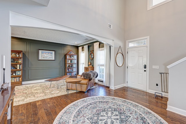 foyer entrance featuring plenty of natural light and dark hardwood / wood-style floors