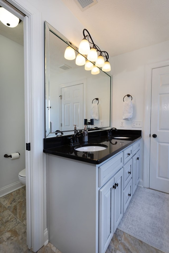 bathroom featuring toilet and vanity