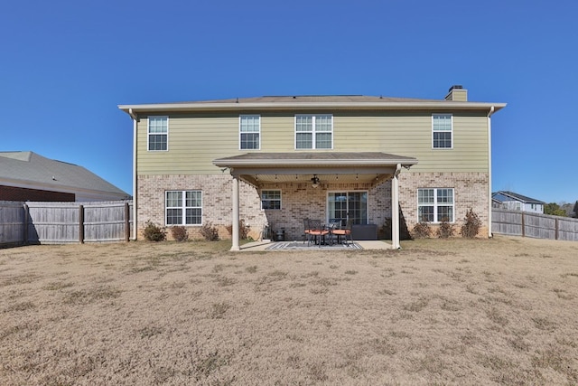 rear view of property with a patio area and a lawn