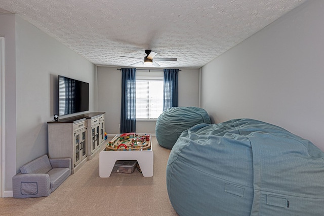 interior space with ceiling fan and a textured ceiling