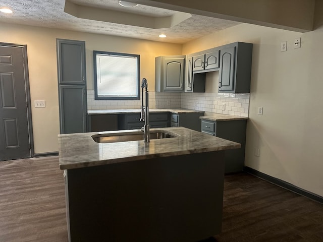 kitchen featuring a textured ceiling and gray cabinetry