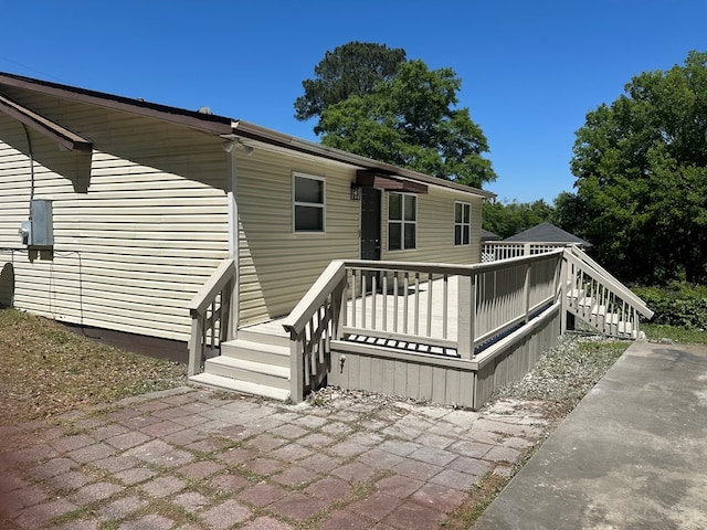 back of property with a wooden deck