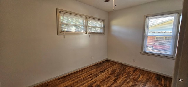 empty room featuring ceiling fan and dark wood-type flooring