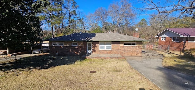 ranch-style house with a front lawn