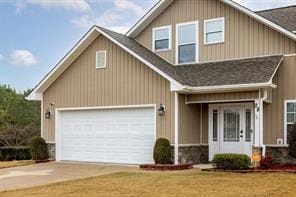 view of front of home with board and batten siding, concrete driveway, and an attached garage