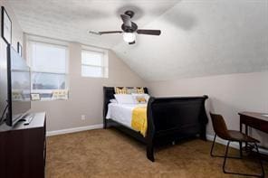 bedroom featuring carpet floors, a ceiling fan, baseboards, and vaulted ceiling