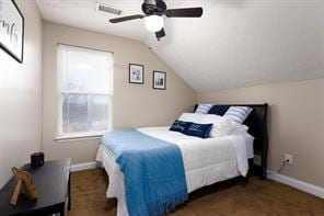 bedroom with vaulted ceiling, baseboards, and ceiling fan