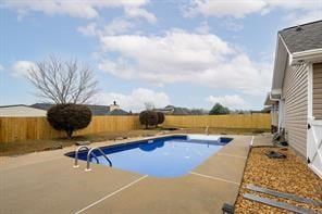 view of swimming pool featuring a patio area and a fenced backyard