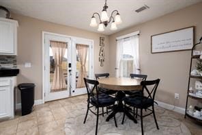 dining area featuring visible vents, baseboards, a notable chandelier, and french doors