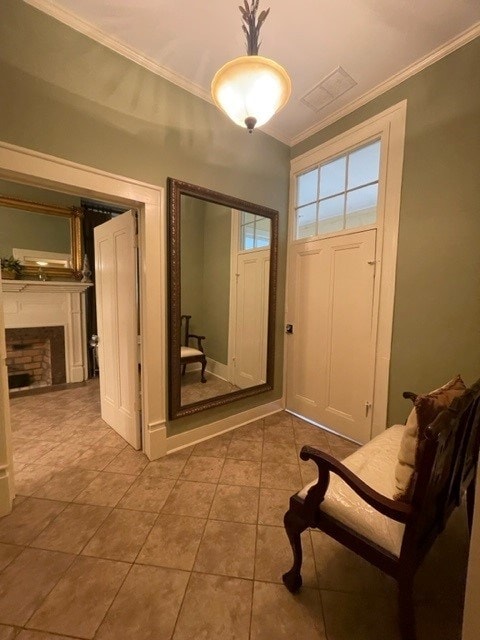 tiled entrance foyer featuring crown molding