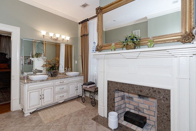 bathroom featuring tile patterned floors, vanity, crown molding, and a high end fireplace