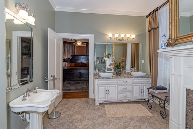 bathroom with crown molding, sink, and tile patterned flooring