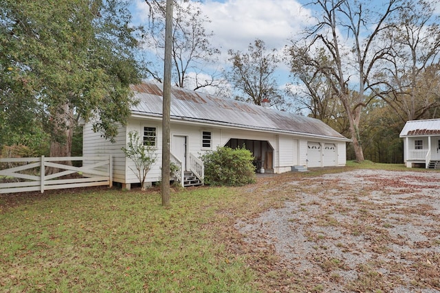 view of front of house with a front yard and a garage