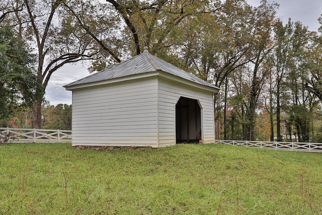 view of outbuilding featuring a lawn