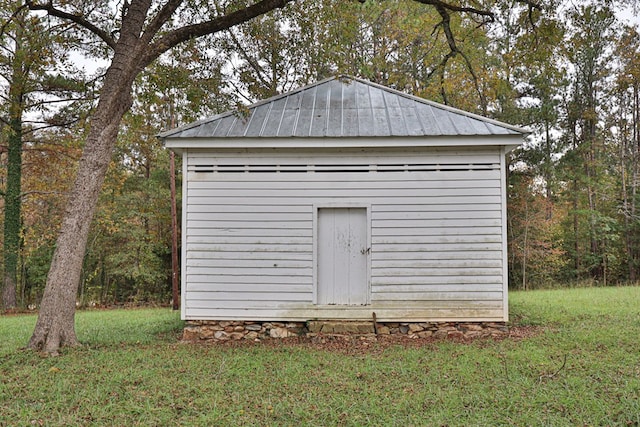 view of outbuilding with a lawn