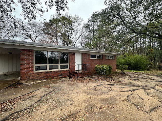 ranch-style house with brick siding and crawl space