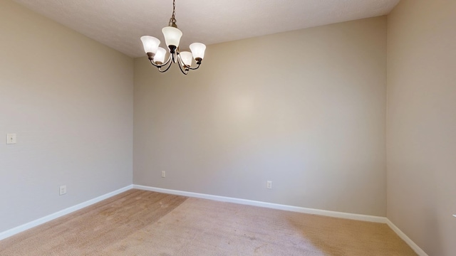 650 Upland Ct, Columbus, GA 31907 - spare room with a chandelier, light colored carpet, and baseboards