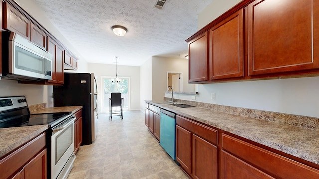650 Upland Ct, Columbus, GA 31907 - kitchen featuring stainless steel appliances, a sink, hanging light fixtures, light countertops, and a chandelier