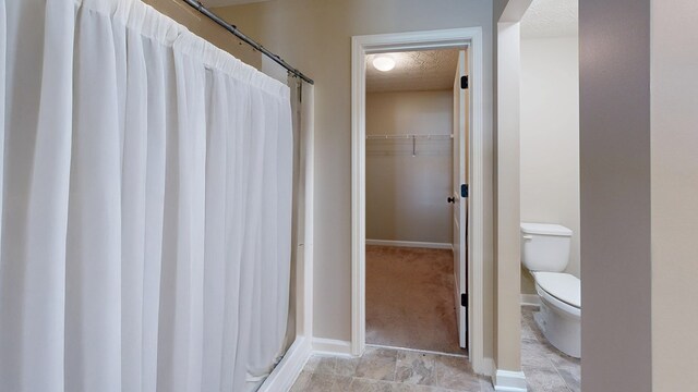 650 Upland Ct, Columbus, GA 31907 - full bathroom featuring a textured ceiling, a shower with curtain, and a walk in closet