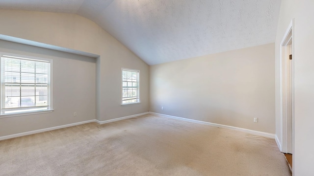 650 Upland Ct, Columbus, GA 31907 - spare room featuring lofted ceiling, carpet, baseboards, and a textured ceiling